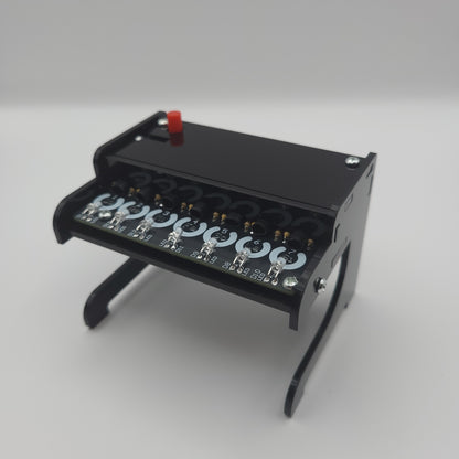 Black Piano Soldering Kit with multiple lights on a gray background