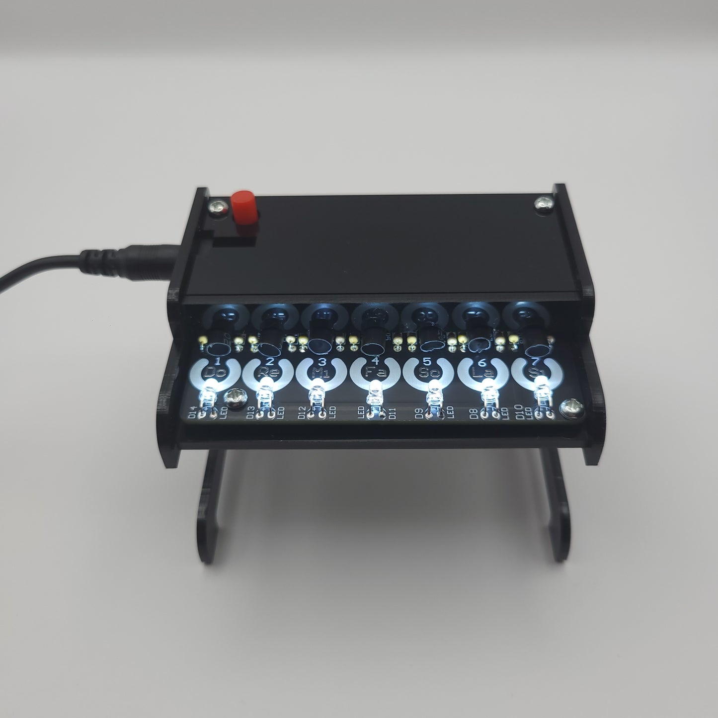 Black Piano Soldering Kit with multiple lights on gray background