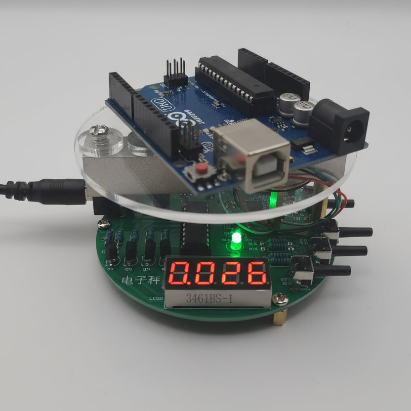Arduino on top of an digital scale kit on a white background