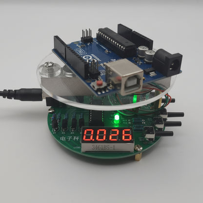 Arduino on top of an digital scale kit on a white background